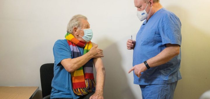 Ian McKellen and the doctor giving him the COVID-19 vaccine