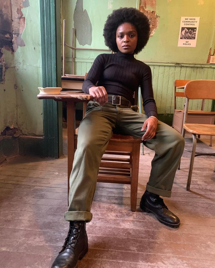 Dominique Thorne in khaki pants and black turtle neck